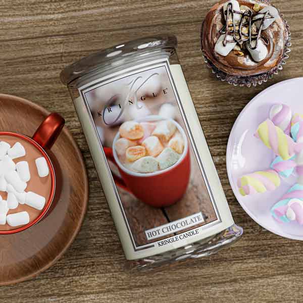 Kringle Candle Hot Chocolate scented candle with a cup of hot chocolate and marshmallows on a wooden table.