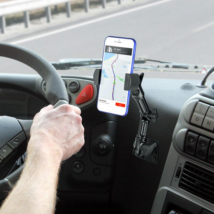 A driver uses a RoadVise Heavy-Duty Multi-Angle Phone Mount—4-Hole AMPS Compatible—to securely hold their phone on the dashboard for navigation, offering stable and adjustable positioning.