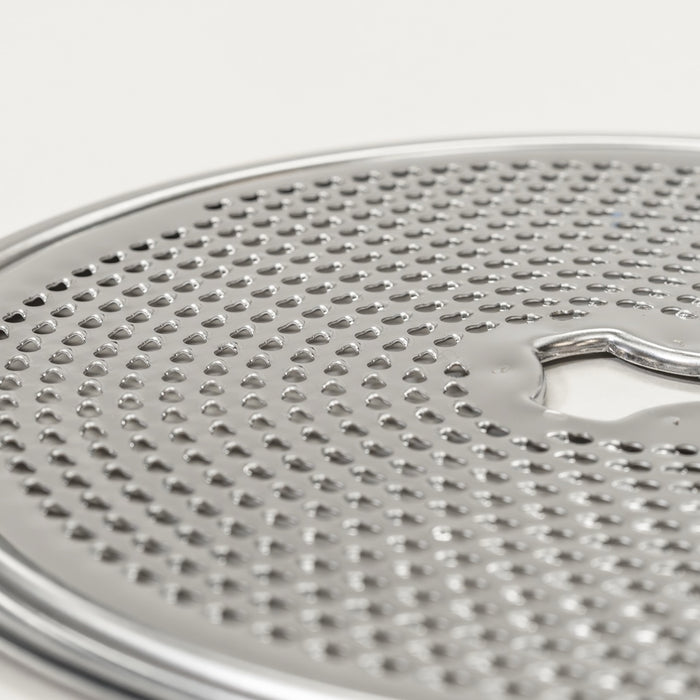 Up close of slicer shredder replacement disk - fine grating on grey background