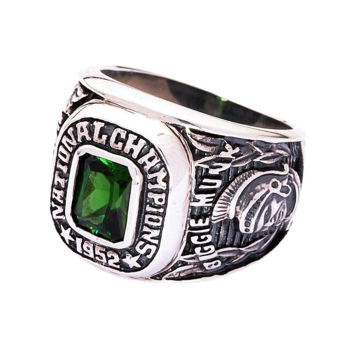 An angled view of the Michigan State championship ring, showing the 1952 and emerald green stone.