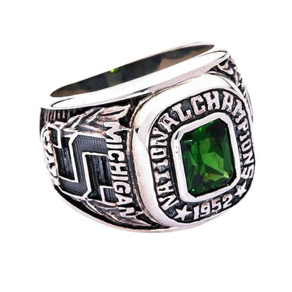 The handcrafted college championship ring in solid 925 sterling silver with a green stone.