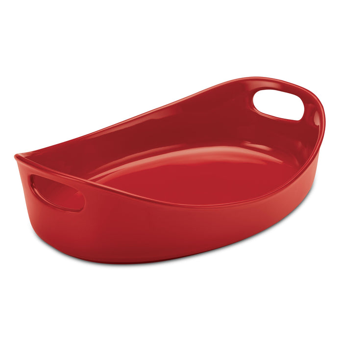 The 4.5-Quart Oval Baker is a red ceramic dish with handles on both sides, making it an indispensable kitchen tool. It is oven safe and easily transitions from baking to cleaning due to its dishwasher-safe convenience.