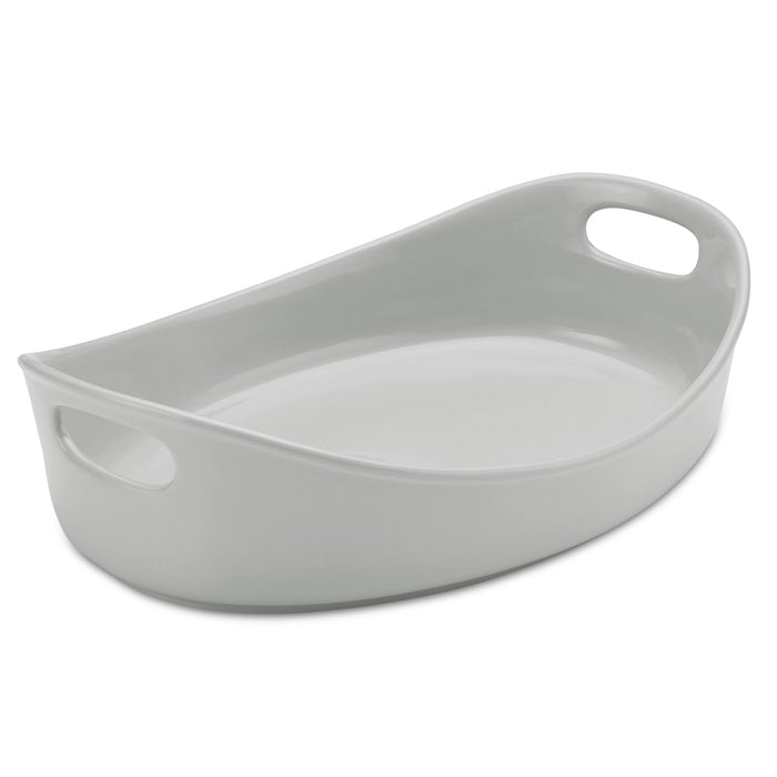 4.5-Quart Oval Baker features a classic white ceramic design with two handles on each end, making it ideal for seamless oven-to-table serving. Enjoy hassle-free cleanup with its dishwasher-safe capability.