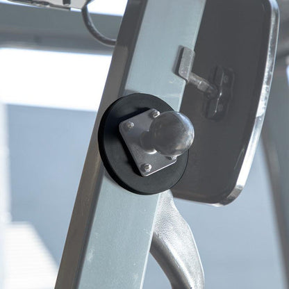 Close-up of gym equipment featuring the 88mm Heavy-Duty Magnetic Base with 4-Hole AMPS Pattern Screw Bolts, a metal arm, black circular stopper, and rounded metallic knob, all attached securely to the frame against a blurred background.