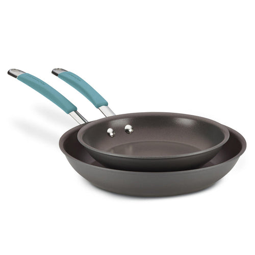 The 9.25" and 11.5" Cucina Hard Anodized Nonstick Frying Pan Set features two expertly stackable frying pans with blue handles, providing versatile cooking options and the convenience of being oven safe.