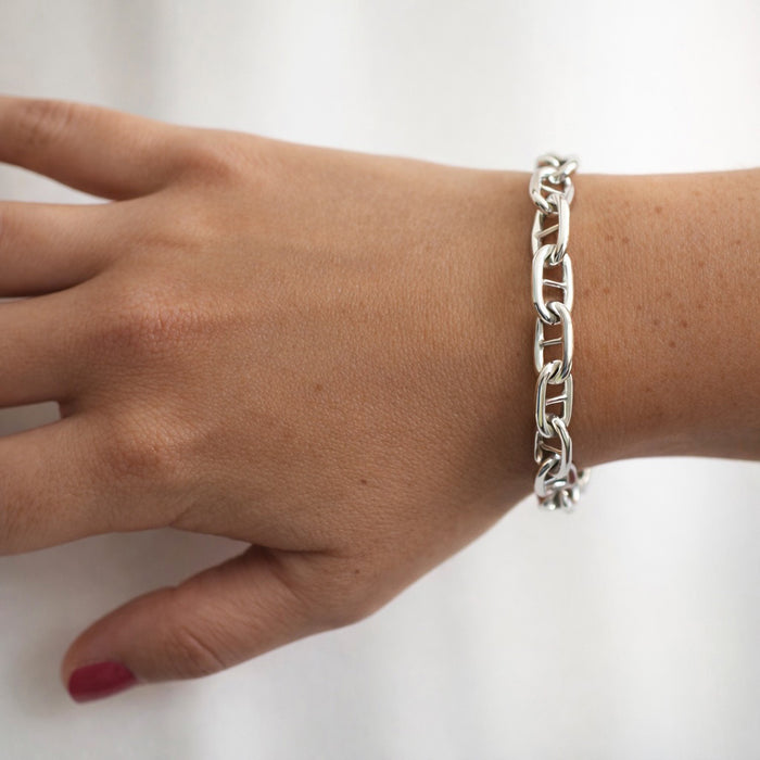 Kvinna som bär ett armband med silverkedja - modell bred Ankarkedja.