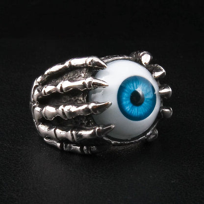 A side view of the skeleton hand eyeball ring, detailing the polished bony fingers and knuckles of the claw.