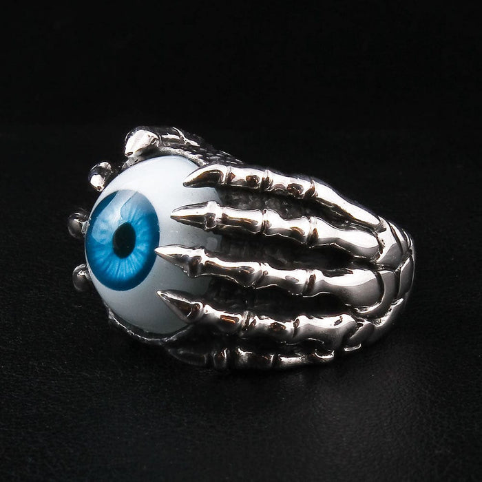 A piece of macabre eyeball jewelry, this gothic ring shows the back of the skeletal hand and its firm grasp.