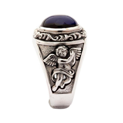 Side design view of handmade silver Cupid ring with blue stone