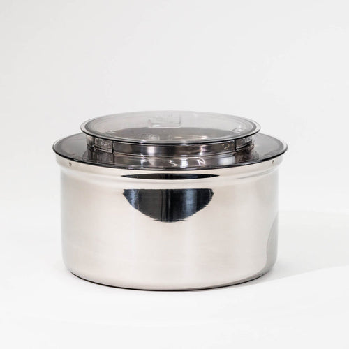 NutriMill bottom drive stainless steel bowl on a grey background