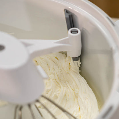 NutriMill bowl scraper scraping icing off of the side of a bowl