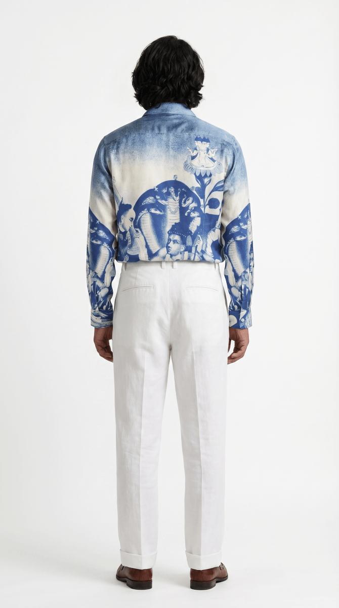 Man wearing the Brahma shirt with white trousers, full length back view