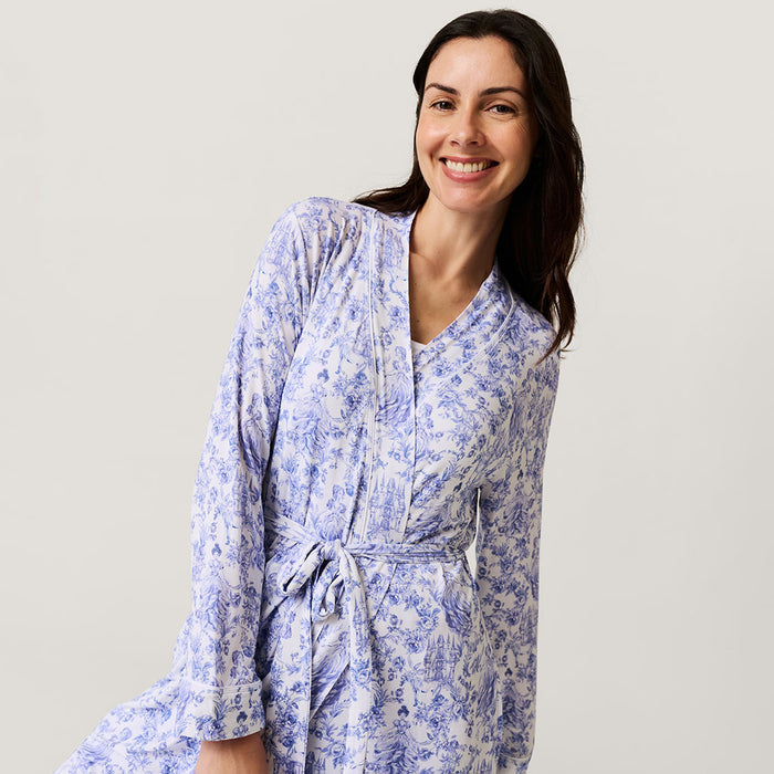 Woman wearing a blue floral robe against a plain background