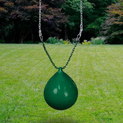 Green inflatable buoy ball swing with metal chains over grassy lawn and trees in the background
