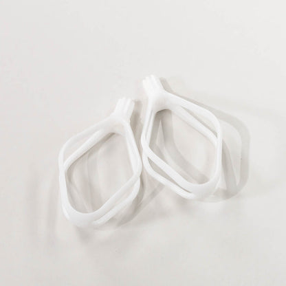 A pair of white plastic cake paddles, designed for mixing batters.
