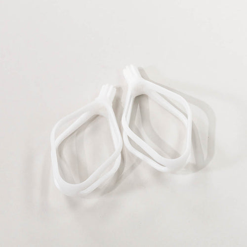 A pair of white plastic cake paddles, designed for mixing batters.