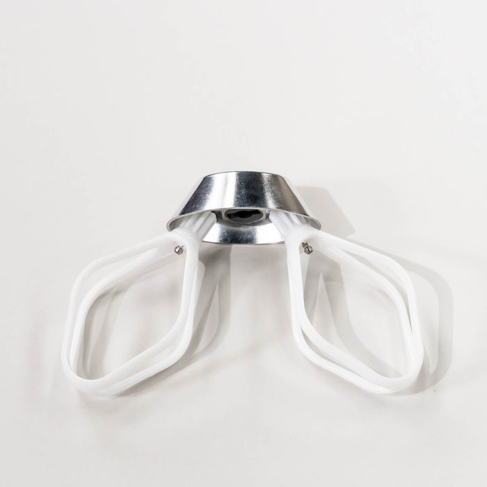 NutriMill cake paddles attached to a NutriMill metal whip driver on a grey background