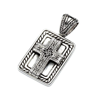 Tilted view highlighting the intricately carved V-shaped bail and openwork frame of the oxidized silver cross pendant.