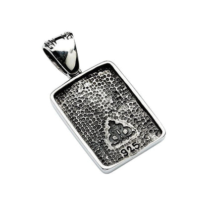 Reverse side of the pendant displaying a stippled texture, crown logo, and 925 sterling silver stamp.