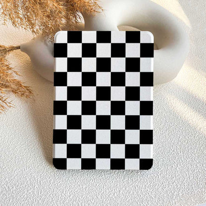 A Kindle case with a black and white checkerboard pattern displayed on a neutral background.