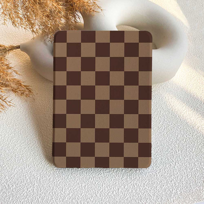 Checkered rectangular object on a textured surface with decorative elements