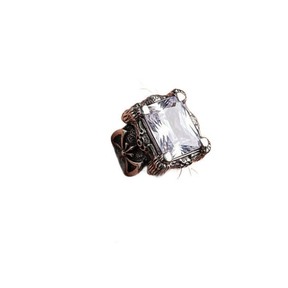 A man's hand wearing the massive gothic dragon ring, showing its impressive size and brilliant sparkle.