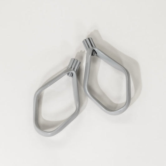 A pair of grey proline cookie paddles with a curved blade design, placed on a white surface.