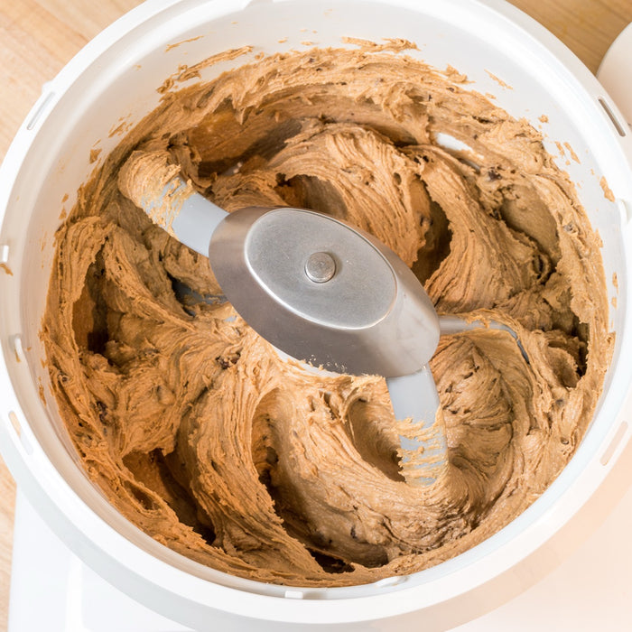 Bosch white universal plus mixer mixing cookie dough with cookie paddles