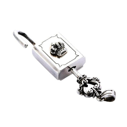 The sterling silver crown padlock pendant shown unlocked with its matching ornate key.