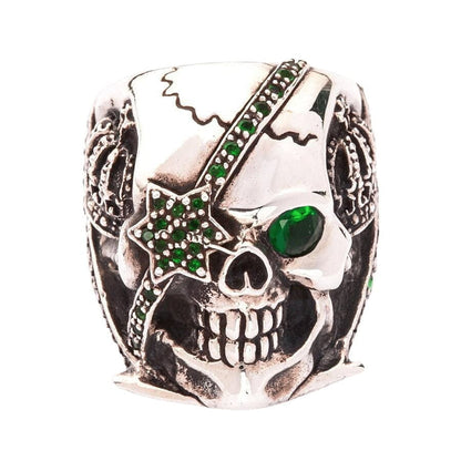Straight front view of the pirate skull ring with piercing emerald green cubic zirconia eyes.
