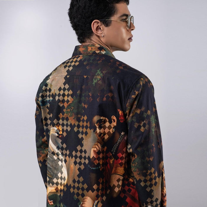 Man wearing the Damayanti's Secret shirt, close three-quarter back view, looking to the side