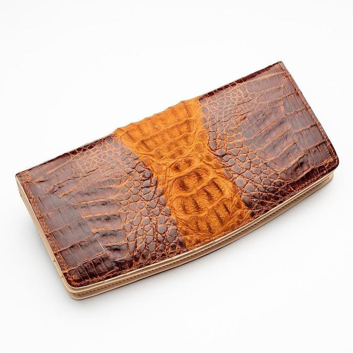 Closed long wallet angled view highlighting glossy dark brown and golden tan crocodile leather patchwork with visible scale texture