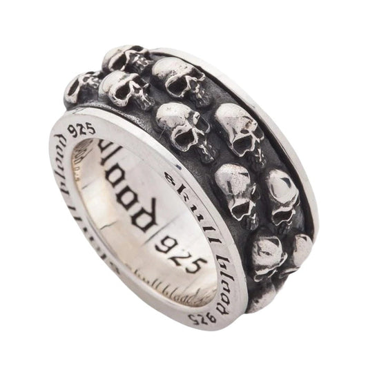 Handcrafted sterling silver skull fidget ring angled view displaying rotating band mechanism