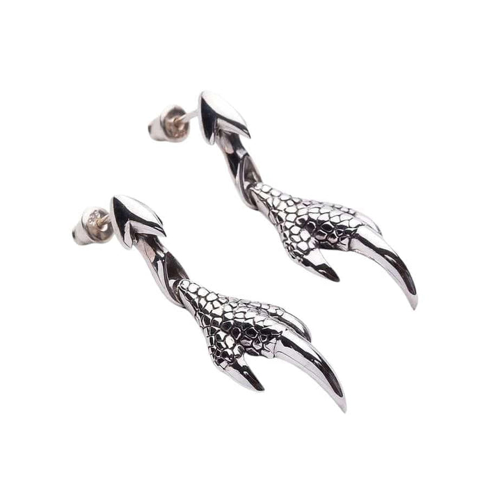 Angled view of dragon talon drop earrings highlighting handcrafted scale texture