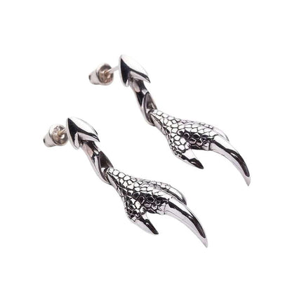 Angled view of dragon talon drop earrings highlighting handcrafted scale texture