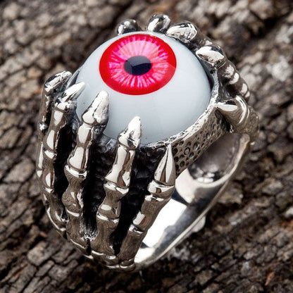 Angled view showing detailed dragon claw design on sterling silver red eyeball ring