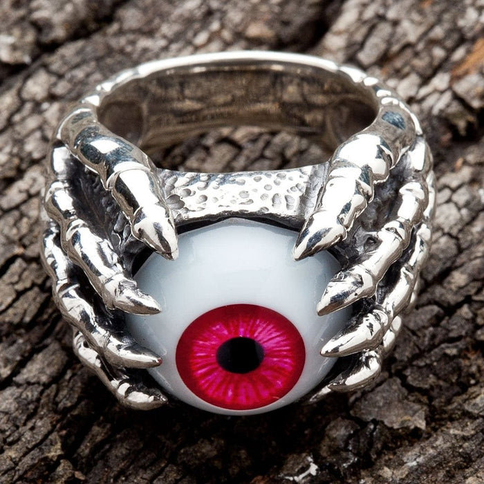 Top down view of handcrafted gothic ring with crimson eyeball and silver claws