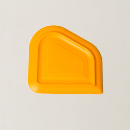 NutriMill orange easy scrape bowl scraper on a white background