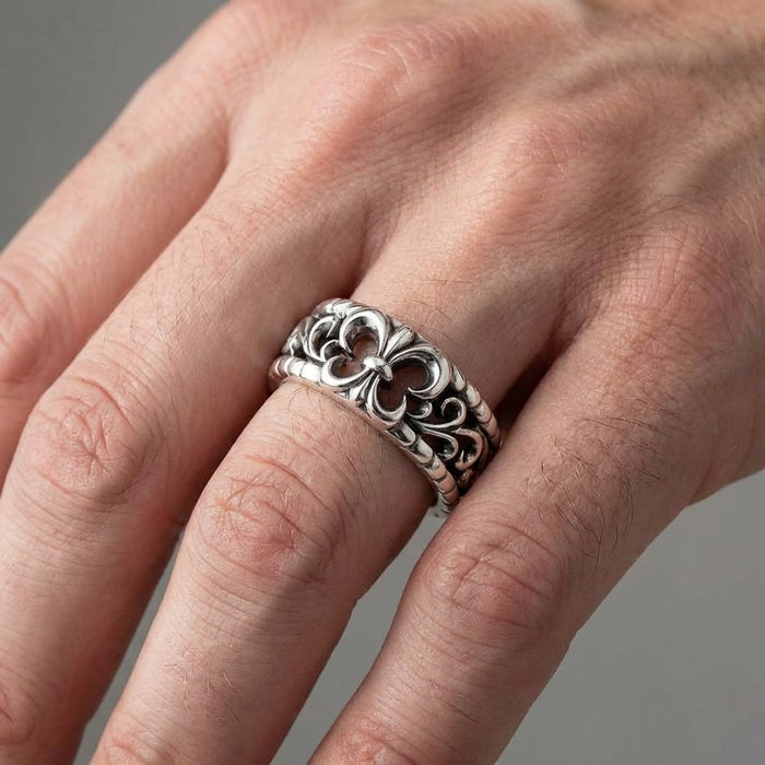 Sterling silver Gothic fleur-de-lis band ring with ornate openwork scrollwork design worn on a man's finger, showcasing the detailed medieval-inspired craftsmanship and oxidized silver finish