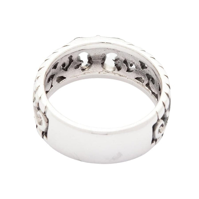 Back view of the sterling silver filigree ring, showing the polished surface and cut-out motifs.
