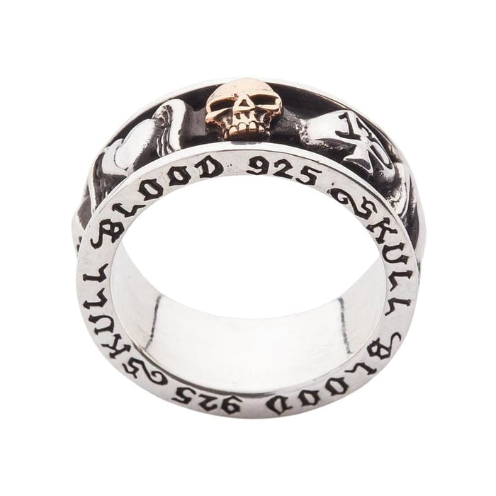 A studio shot of the two-tone gold skull spinner ring on a white background.