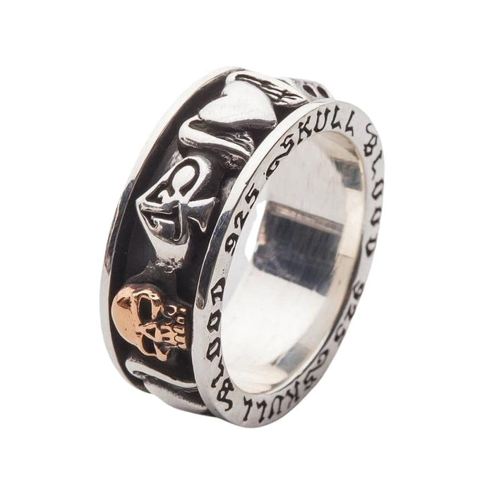 A detailed macro shot of the 13 spade and gold-plated skull on the spinner ring.