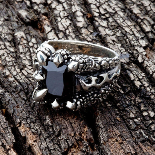 Top view of the black gothic claw ring, showing dragon talons gripping a square black stone.