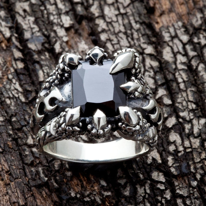 A front-on view of the sterling silver dragon claw ring with a large black stone, highlighting the gothic design.