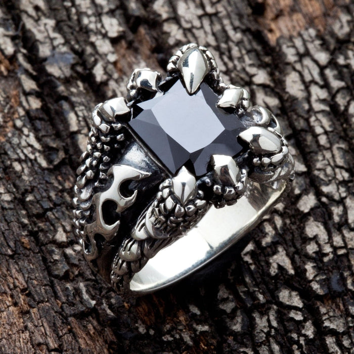 Side profile of the black stone claw ring, detailing the intricate, scaly band and claw setting.