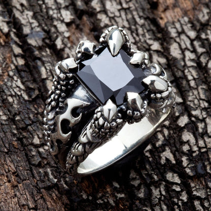 Side profile of the black stone claw ring, detailing the intricate, scaly band and claw setting.
