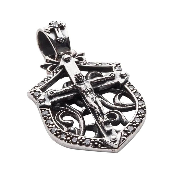 Angled view showing the depth and stone settings of the silver cross pendant
