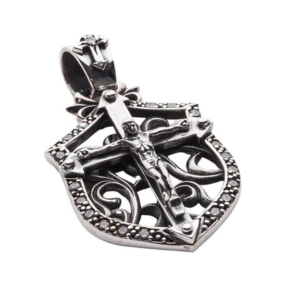 Angled view showing the depth and stone settings of the silver cross pendant
