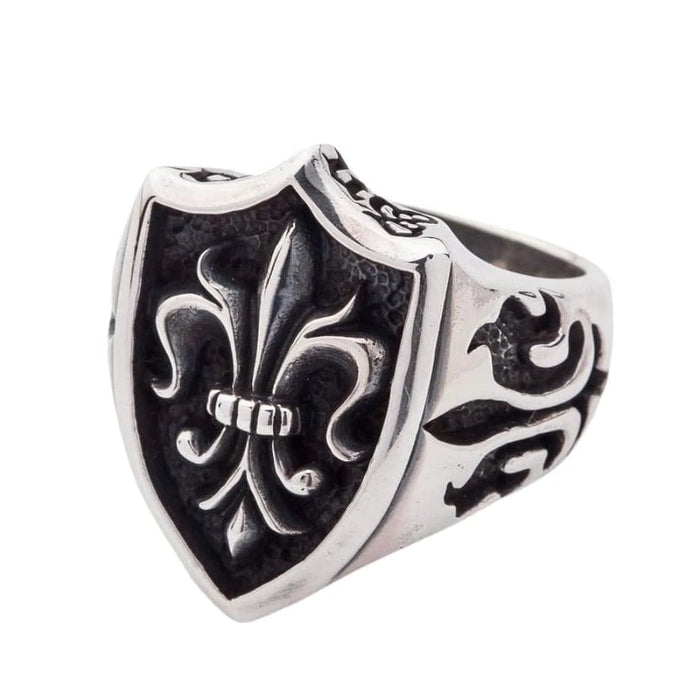 An angled side view of the gothic fleur de lis ring, showing the band's medieval carvings.