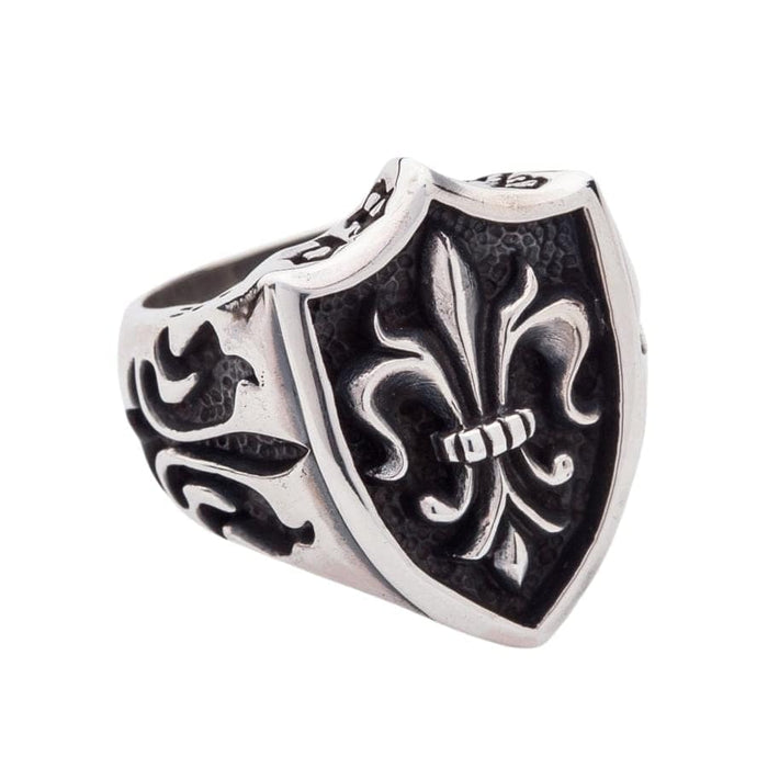 close-up of the fleur de lis shield ring, highlighting the oxidized, textured background.